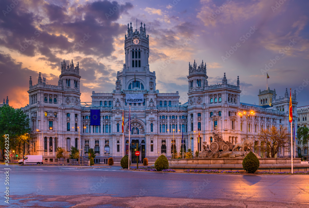 Cybele's Square (Plaza de la Cibeles) and Central Post Office (Palacio de Comunicaciones) in Madrid, Spain. Sunset cityscape of Madrid