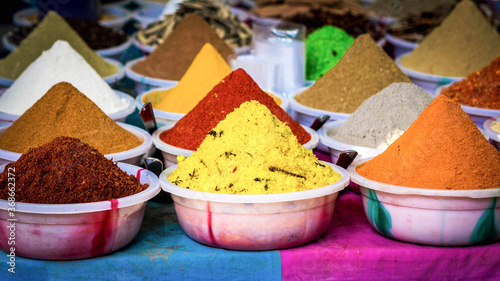 Varied indian colourful spices neatly put up for sale in a market