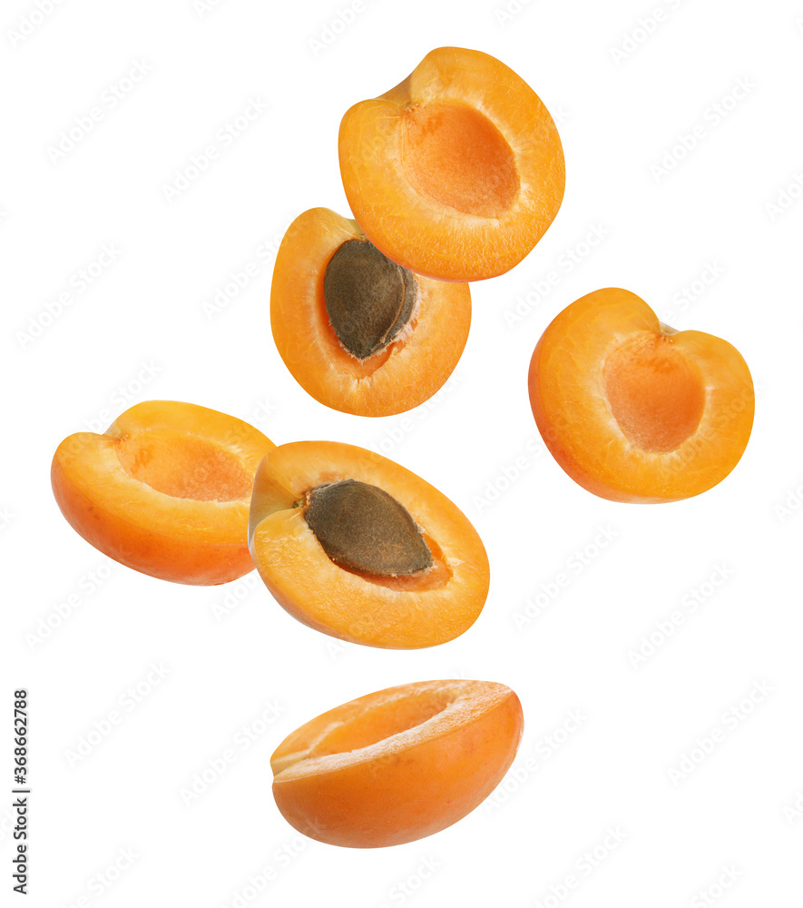 Cut ripe apricots falling on white background Cut ripe apricots falling on white background