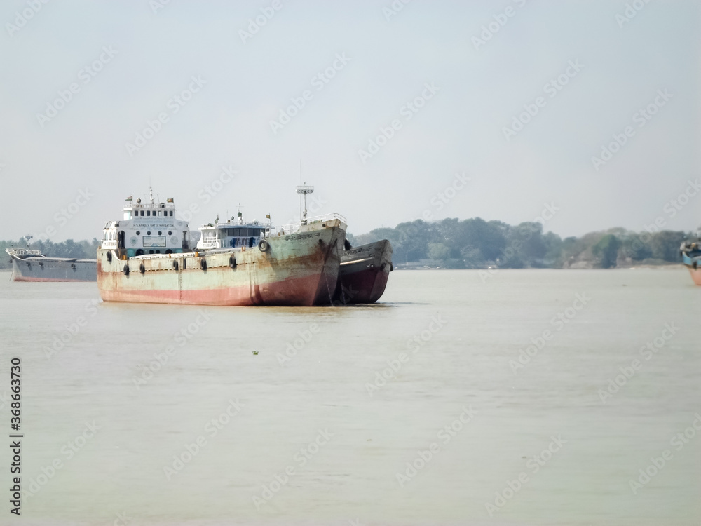 Container Ship in Ganga river. Marine Cargo Ships at Calcutta Port and Haldia Port for commercial freight transport from Kolkata to Bangladesh. Hooghly river West Bengal, India South Asia Pac May 2020