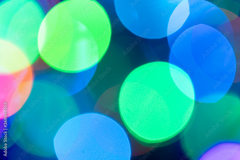 Christmas or New Year festive blue and green bokeh background closeup. Large Xmas macro round bokeh backdrop. Christmas or New Year festive blue and green bokeh background closeup. Large Xmas macro round bokeh backdrop.