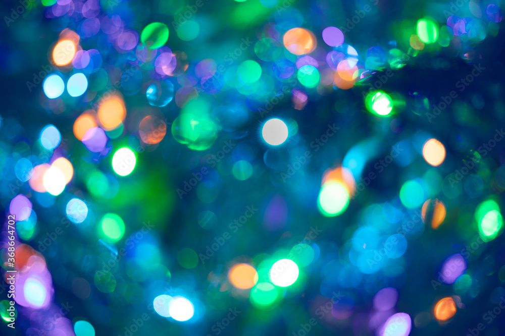 Beautiful multicolored bokeh in purple-blue-green color as background or wallpapers. Christmas or New Year defocused bokeh background.