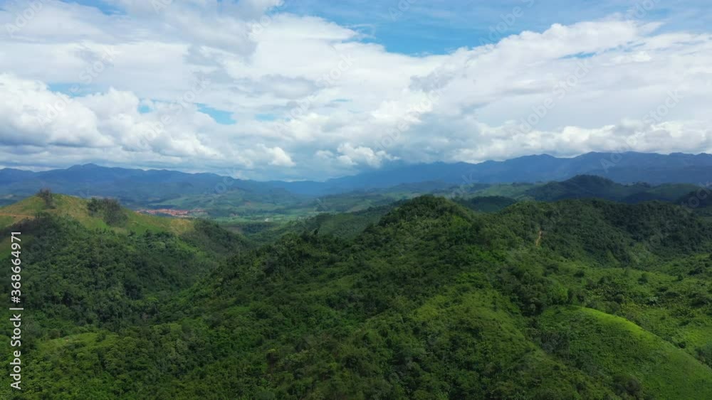 Green forests in the middle of the countryside in Asia, Laos, between Vientiane and Luang Prabang, in summer on a sunny day. Green forests in the middle of the countryside in Asia, Laos, between Vientiane and Luang Prabang, in summer on a sunny day.