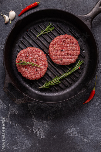 Fresh raw minced homemade grill beef burgers in a frying pan
