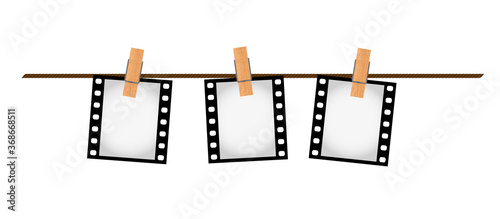 Three photo film slides on a rope with clothepins