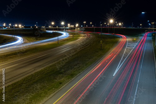 Light trails from vehicles travelling on the Circle Drive freeway late at night in Saskatoon, Saskatchewan Canada