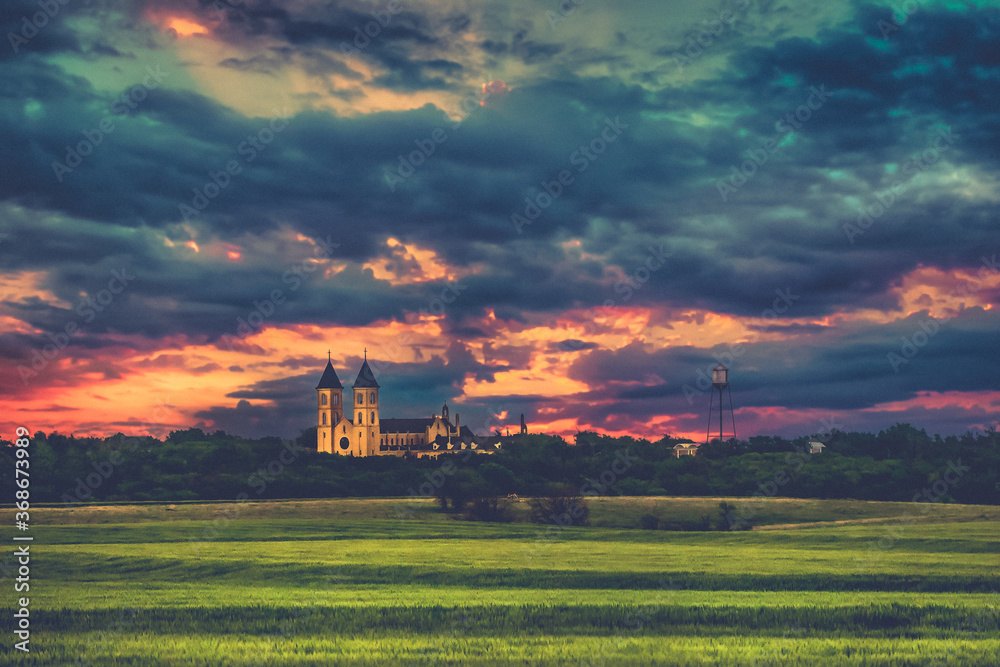 Fototapeta premium Victoria, KS USA - Panorama View of the Midwest Wheat Field Prairie and Cathedral of the Plains in Victoria Kansas USA Prairie in Sunset Sky Clouds