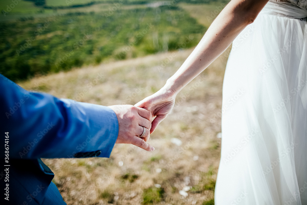Close-up of a woman and a man holding out their hands, two people holding hands. The symbol is a sign of sincere feelings, a loved one. the concept of true friendship, outdoors