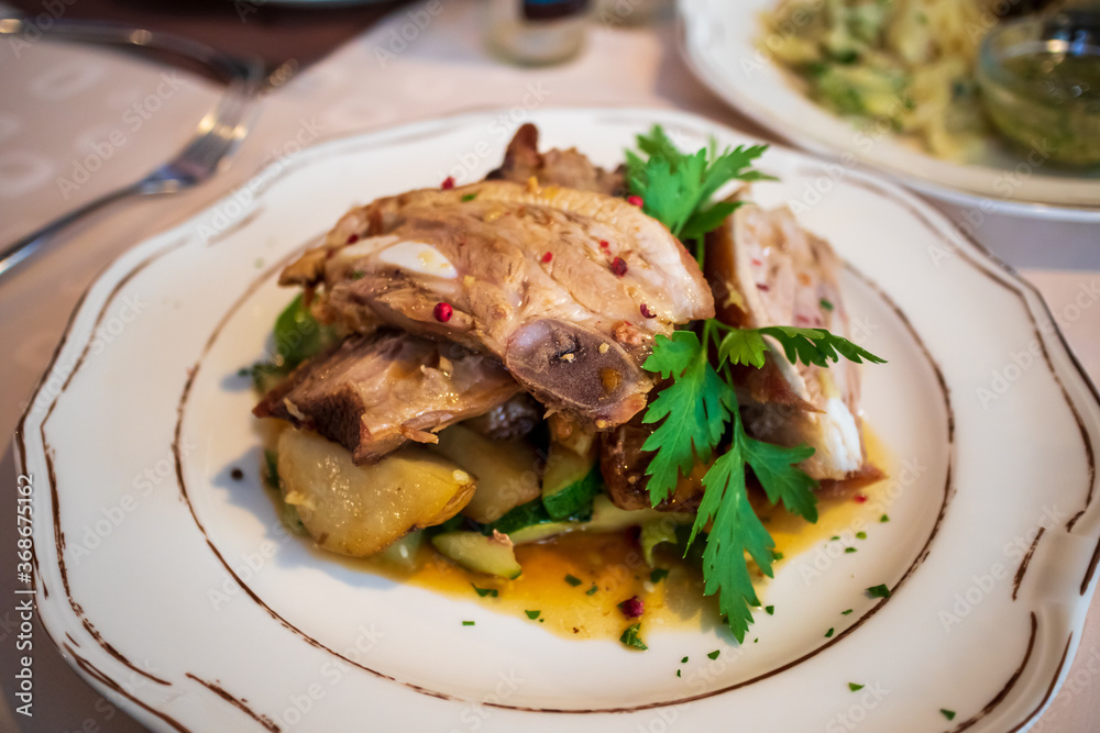 Sliced pork ribs on a plate with vegetables