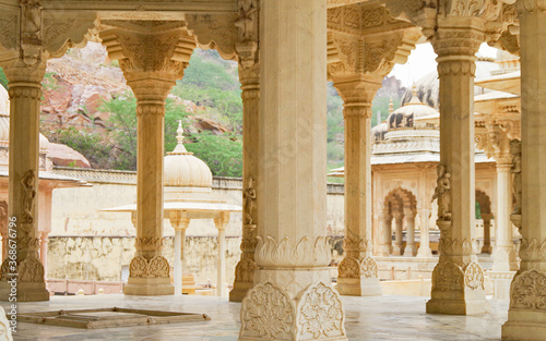 Architectural details of Royal Gaitor Tumbas or Tombs in Jaipur, Rajasthan in India with  columns, domes and palace style buildings with scenic landscape photo