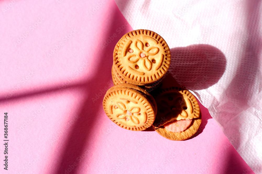 Top view of stacked biscuits on pink isolated background. sweet biscuits, Cream biscuits, Stacked biscuits