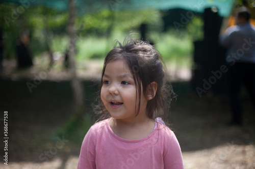 Girl 4 years old in the forest. Little girl of Asian appearance