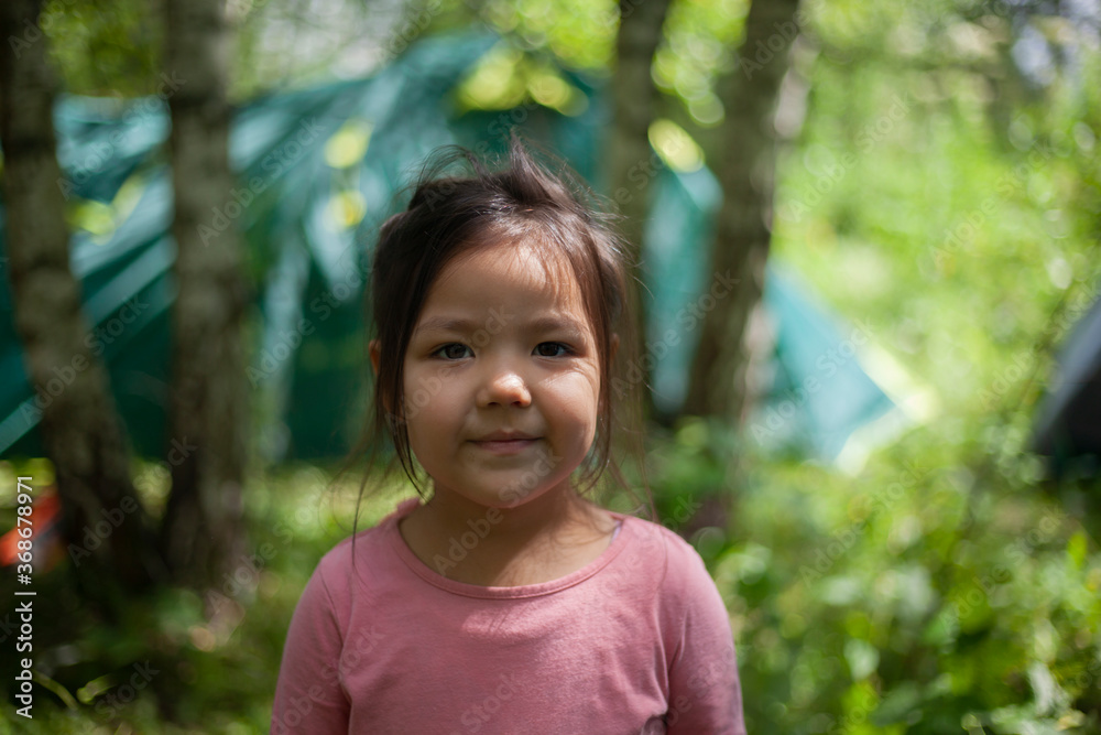 Girl 4 years old in the forest. Little girl of Asian appearance Girl 4 years old in the forest. Little girl of Asian appearance