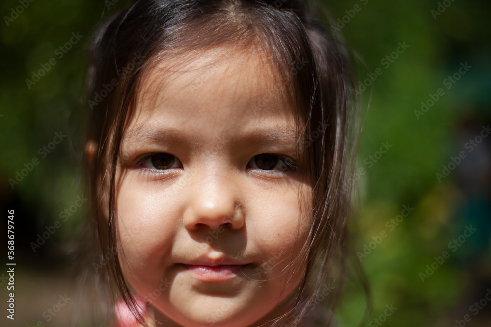 Girl 4 years old in the forest. Little girl of Asian appearance Girl 4 years old in the forest. Little girl of Asian appearance