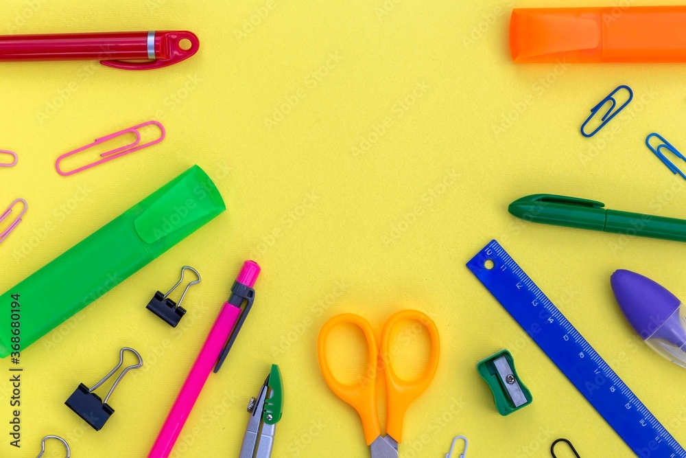 Creative flat lay with empty copy space for your text in the semicircle frame of school supplies as pens, pencils, ruler, scissors, sharpener, marker. Creative flat lay with empty copy space for your text in the semicircle frame of school supplies as pens, pencils, ruler, scissors, sharpener, marker.