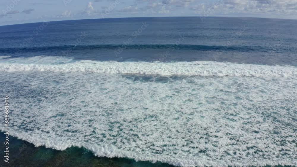 Slow motion Top down aerial view of the ocean giant waves, foaming and splashing. Beautiful water texture background, sunny day over the sea, drone footage follow the waves Slow motion Top down aerial view of the ocean giant waves, foaming and splashing. Beautiful water texture background, sunny day over the sea, drone footage follow the waves