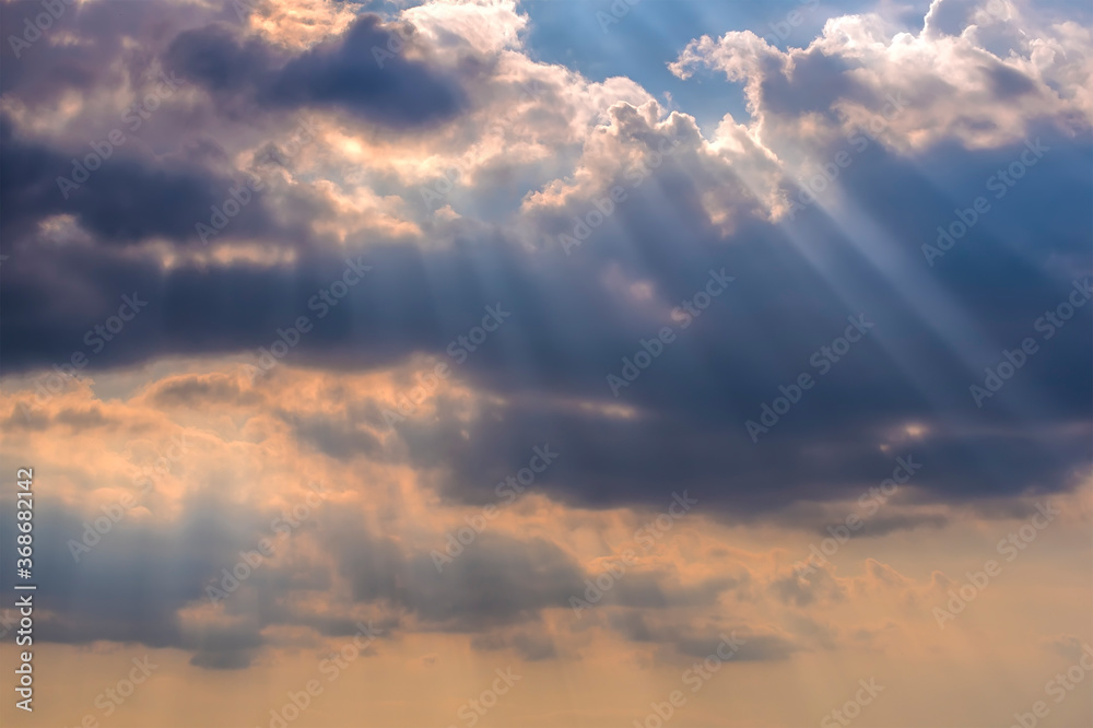Shafts of light pierce the clouds above Morston Quay, Norfolk, UK