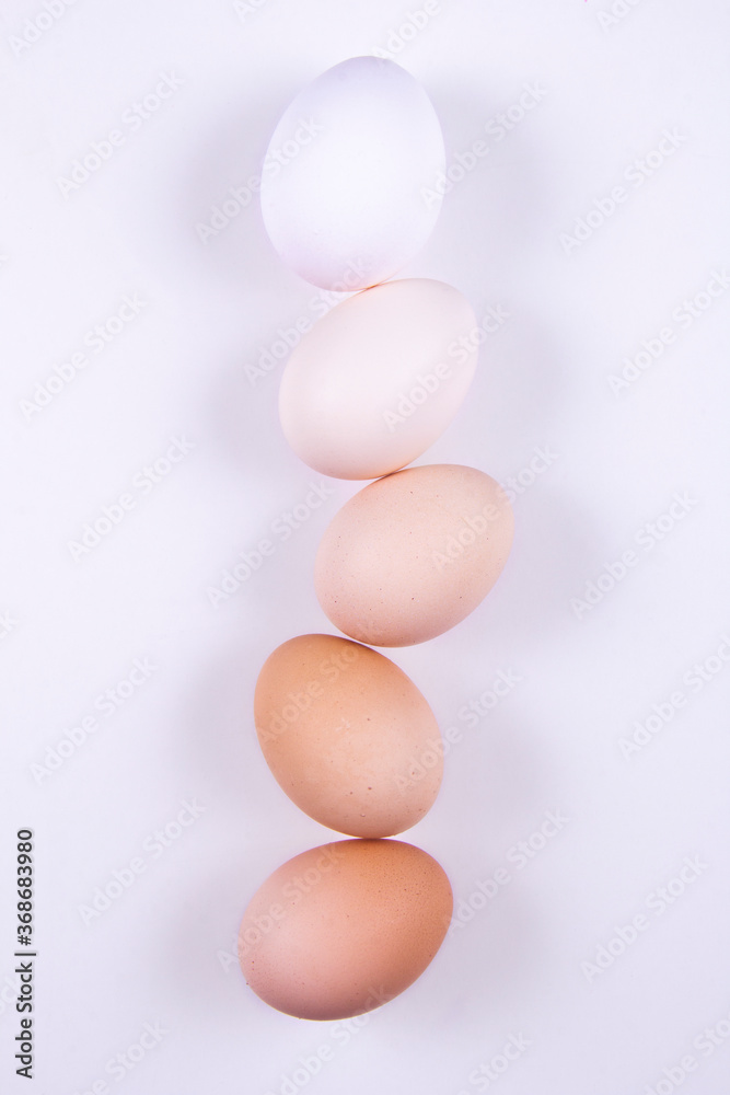 Native eggs are placed in a dish or basket or white cloth in order of color.