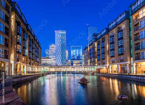 Photography Night scene of the Canary Wharf financial buildings and residential houses refle