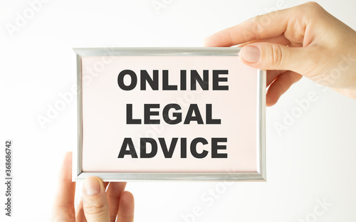 Online Legal Advice text on card held by hands.