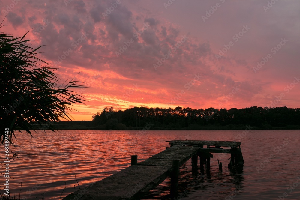 beautiful lake scenery with jetty and fantastic afterglow 