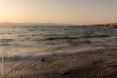 Fototapeta Naklejka Na Ścianę i Meble -  Sunset on beach, sunset over sea wavs 