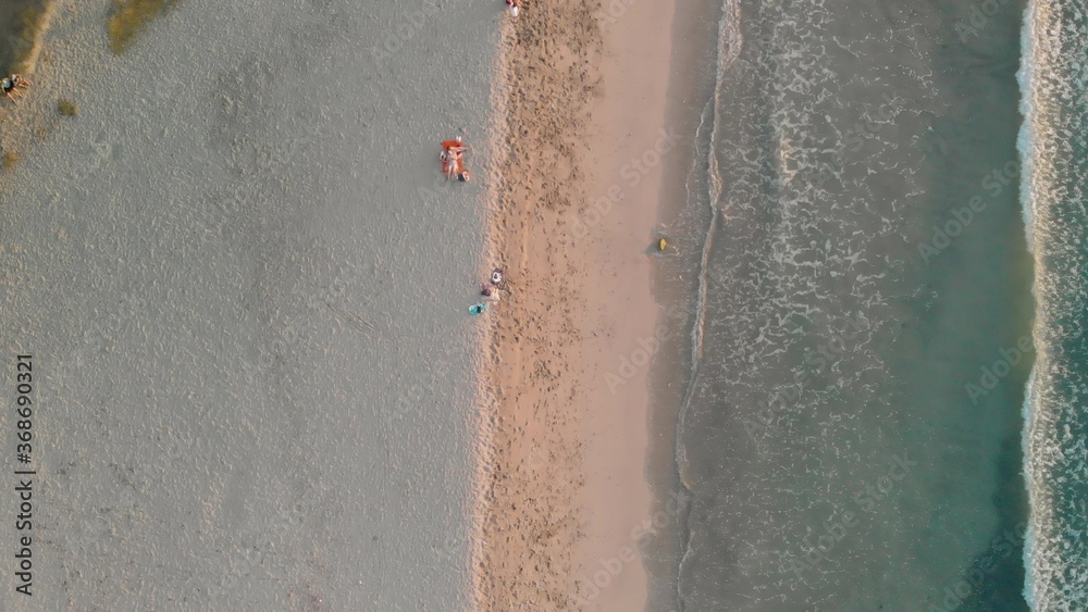 Overhead aerial view of small waves on the shoreline