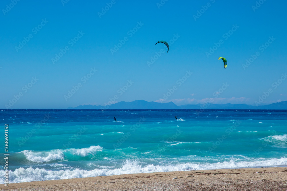 Agios Ioannis Beach In Lefkas Island Greece with two kite surfers Agios Ioannis Beach In Lefkas Island Greece with two kite surfers