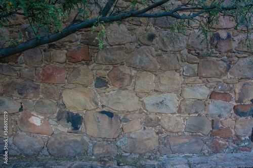 A colorful stone wall on an old building photo