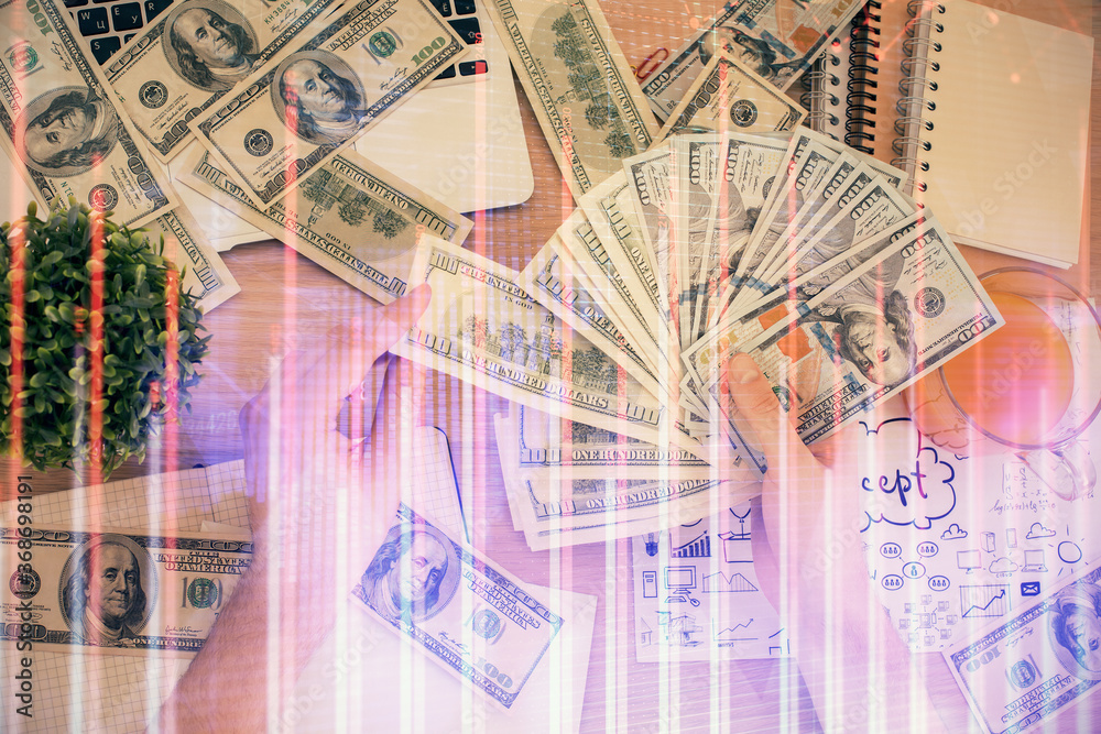 Multi exposure of financial graph drawing hologram and USA dollars bills and man hands. Analysis concept. Multi exposure of financial graph drawing hologram and USA dollars bills and man hands. Analysis concept.