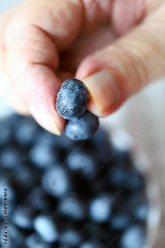 Selective focus. Macro. Blueberries in a man's hand. A man's hand holds blueberries. Selective focus. Macro. Blueberries in a man's hand. A man's hand holds blueberries.