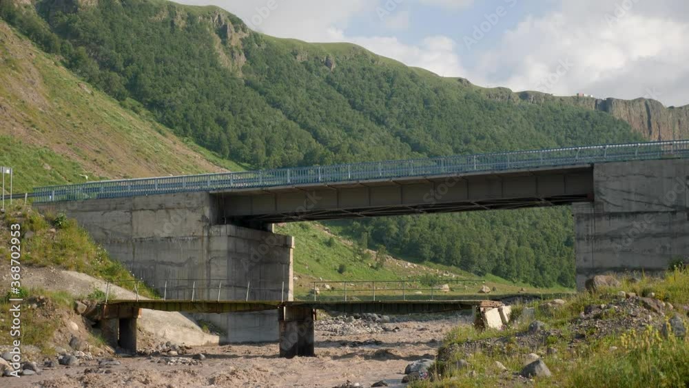 stormy mountain river in the caucasus passing under the bridge road stormy mountain river in the caucasus passing under the bridge road