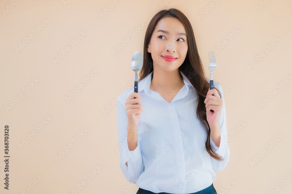 Portrait beautiful young asian business woman with spoon and fork Portrait beautiful young asian business woman with spoon and fork