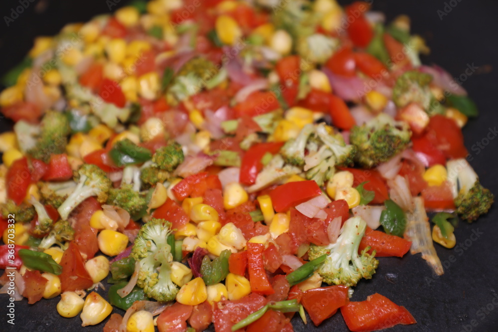 Vegetable Salad saute in Pan with Tomato Brocolli capsicum ready to be prepared for Khow Suey Vegetable Salad saute in Pan with Tomato Brocolli capsicum ready to be prepared for Khow Suey