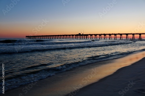 pier at the beach during sunset 