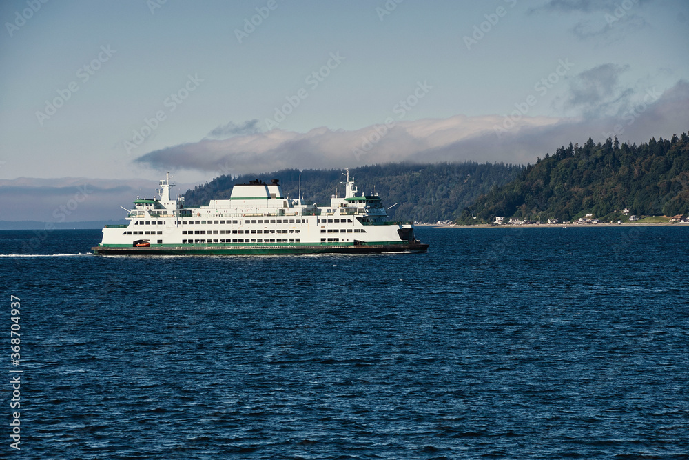  2020-08-01 A LARGE PASSENGER FERRY ALONG THE SHORELINE OF WHIDBEY ISLAND WITH CLOUD COVER MOVING IN