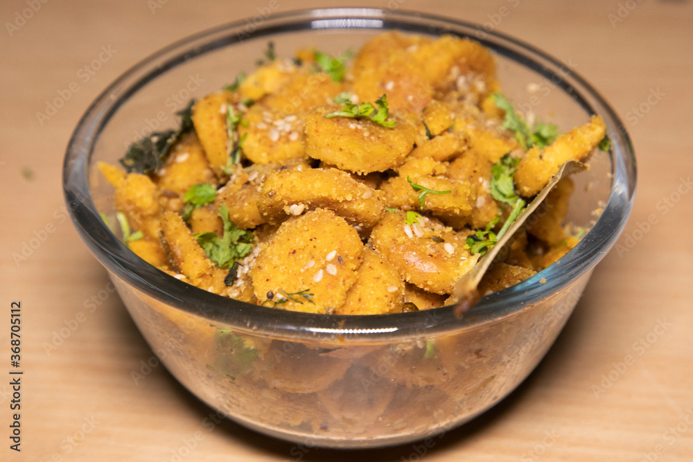 Gattey ki sabji Indian Delicious Cuisine of Rajasthan made with Roasted Boiled Gram Flour mixed with Seasame Seeds and Cumin Seeds in Glass bowl and Frying Pan decorated with Leaf Spatula Gattey ki sabji Indian Delicious Cuisine of Rajasthan made with Roasted Boiled Gram Flour mixed with Seasame Seeds and Cumin Seeds in Glass bowl and Frying Pan decorated with Leaf Spatula