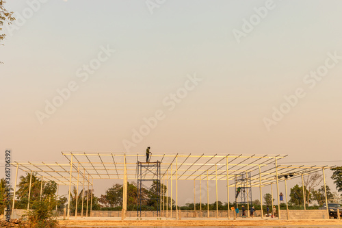 Mechanic is constructing a large building structure.