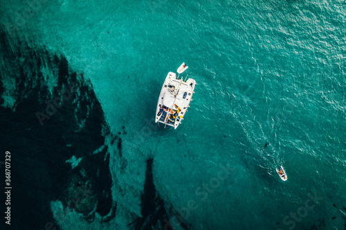 Aerial view of a catamaran anchored and a digny at Lavezzu Island, Corsica, France. photo