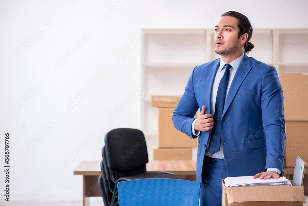 Young male employee in relocation concept