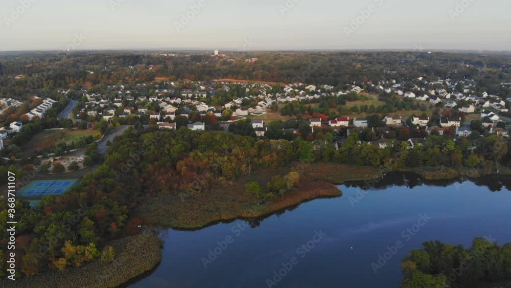 Aerial view of residential a town areas along the river with private houses bench in autumn landscape Aerial view of residential a town areas along the river with private houses bench in autumn landscape