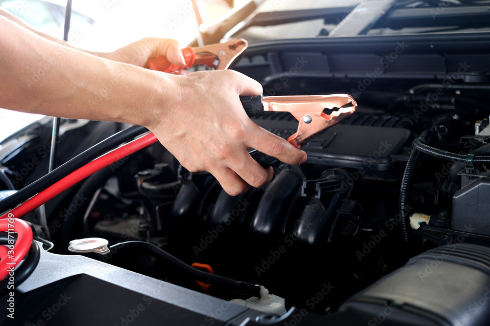 Car maintenance technician He is checking the auto engine, car inspection center.