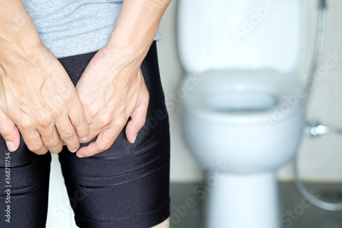 Man's hand, he holds a roll of toilet paper Going to the bathroom Toilet toilet background