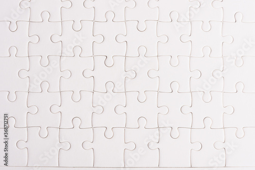 Top view flat lay of paper plain full white jigsaw puzzle game texture background, quiz calculation concept