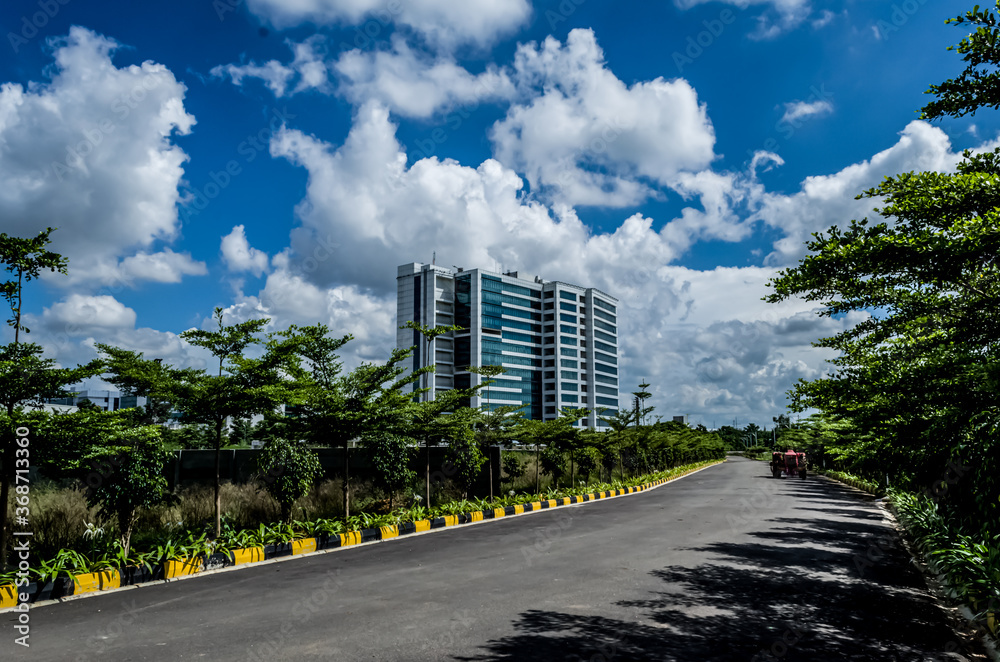Green natures and blue sky and single empty road office building Green natures and blue sky and single empty road office building