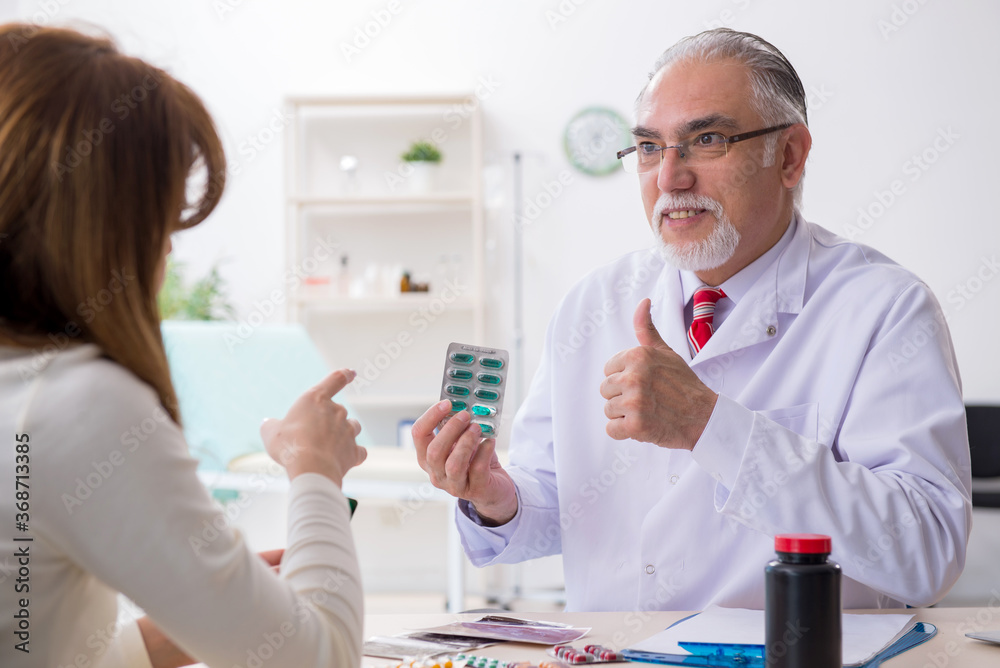 Young woman visiting experienced doctor Young woman visiting experienced doctor