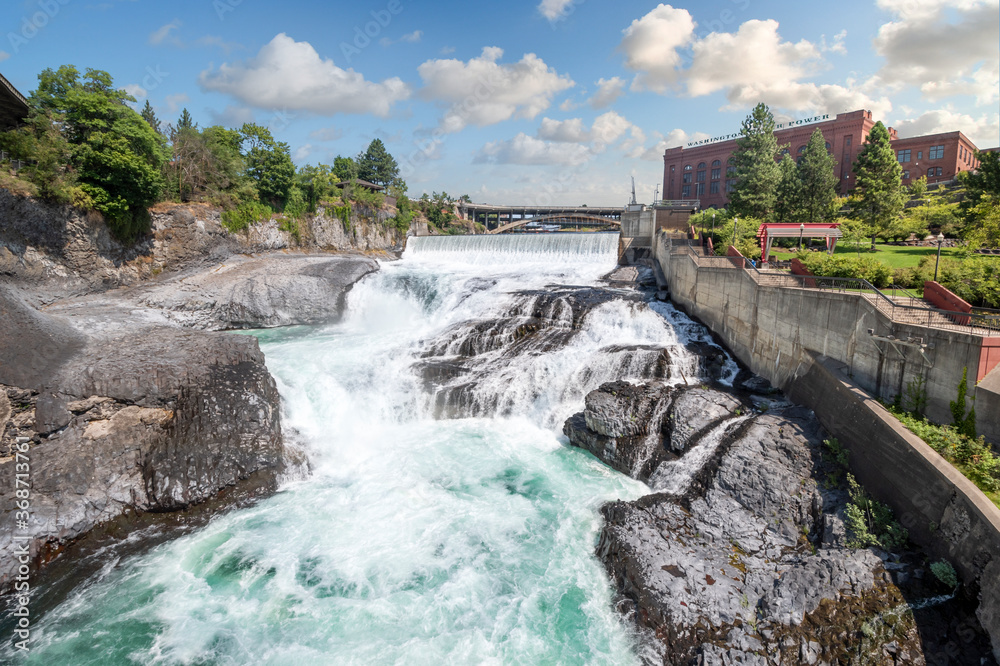The Spokane Falls Dam next to the old Water and Power building in Riverfront Park, downtown Spokane, Washington, USA