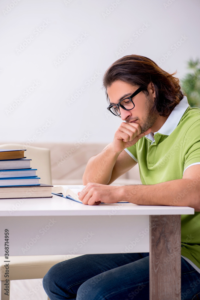 Young male student preparing for exams at home Young male student preparing for exams at home