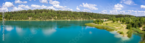 aerial panorama of beautiful blue lake and green summer forest in Belarus under blue sky. summer landscape.