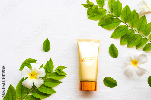 natural cosmetics sunscreen spf50 health care for skin face with flowers frangipani  leaf of lifestyle woman relax in summer season arrangement flat lay style 